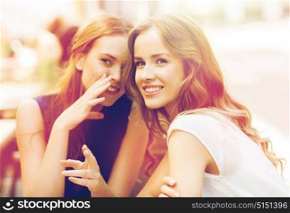 people communication and friendship concept - smiling young women drinking coffee or tea and gossiping at outdoor cafe. young women drinking coffee and talking at cafe