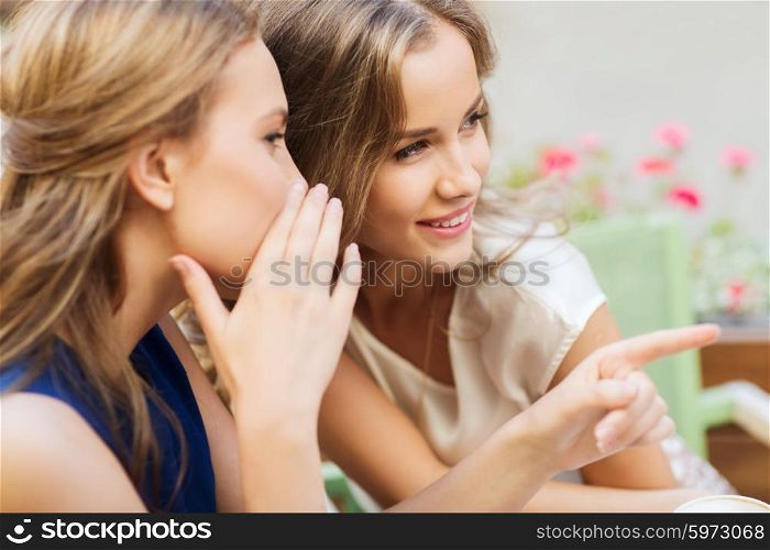 people, communication and friendship concept - smiling young women gossiping at outdoor cafe