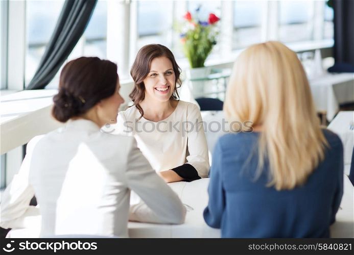people, communication and lifestyle concept - happy women meeting and talking at restaurant