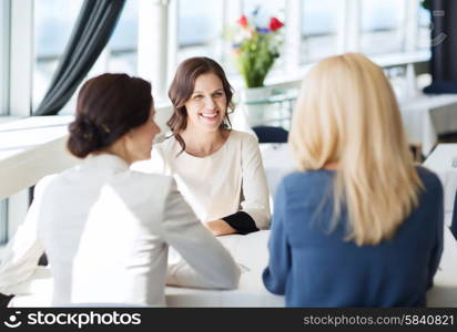 people, communication and lifestyle concept - happy women meeting and talking at restaurant