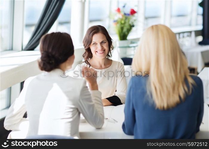 people, communication and lifestyle concept - happy women meeting and talking at restaurant