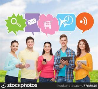 people, communication and technology concept - smiling friends with smartphones and tablet pc computers over blue sky and grass background with doodles
