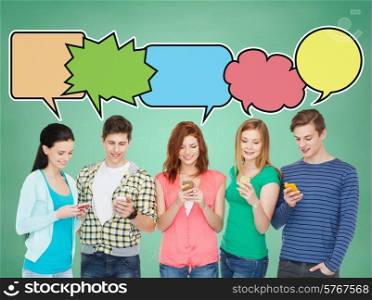 people, communication, school and technology concept - smiling friends showing blank smartphones screens over blue background with doodles