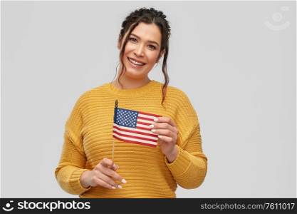 people concept - happy smiling young woman with pierced nose with flag of united states of america over grey background. happy woman with flag of united states of america