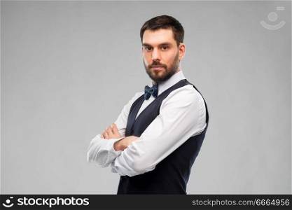 people concept - man in party clothes and bowtie over grey background. man in party clothes and bowtie