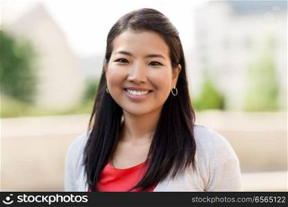 people concept - portrait of happy smiling asian woman outdoors. portrait of happy smiling asian woman outdoors