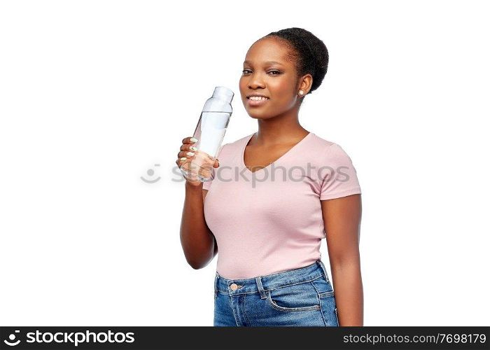 people concept - portrait of happy smiling young african american woman drinking water from reusable glass bottle over white background. happy african woman drinks water from glass bottle