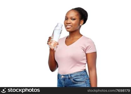 people concept - portrait of happy smiling young african american woman drinking water from reusable glass bottle over white background. happy african woman drinks water from glass bottle