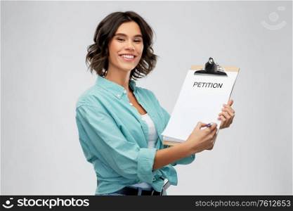 people concept - portrait of happy smiling young woman in turquoise shirt with petition on clipboard and pen over grey background. smiling woman with petition on clipboard and pen