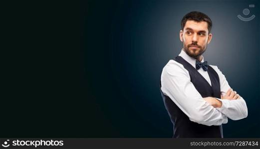 people concept - serious man in white shirt, waistcoat and bowtie over black background. man in shirt and bowtie over black background