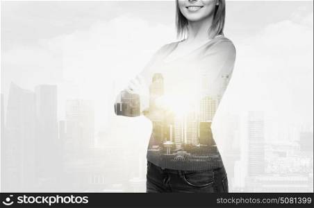 people concept - smiling young woman in casual clothes over city buildings and double exposure effect. smiling woman in casual clothes
