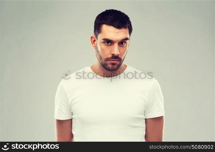 people concept - young man portrait over gray background. young man portrait over gray background