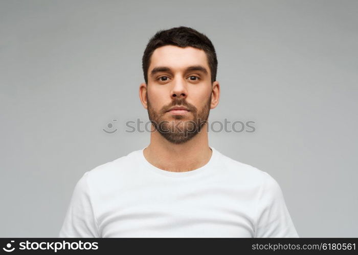 people concept - young man portrait over gray background. young man portrait over gray background