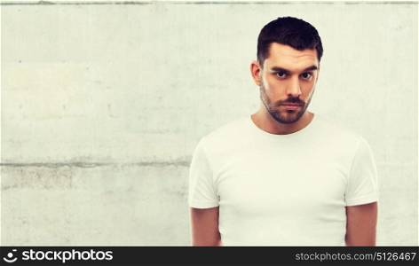 people concept - young man portrait over gray wall background. young man portrait over gray wall background