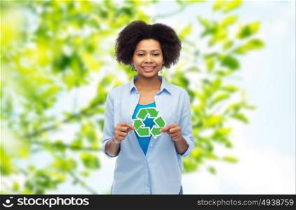people, conservation, ecology and environment concept - happy afro american young woman with recycling symbol over summer natural background. happy afro american woman over natural background