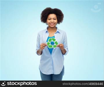 people, conservation, ecology and environment concept - happy afro american young woman with recycling symbol over blue background. happy afro american woman over blue background