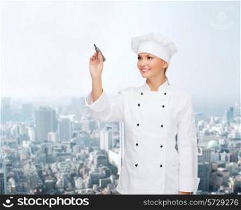 people, cooking and advertisement concept - smiling female chef, cook or baker with marker writing something on virtual screen over city background