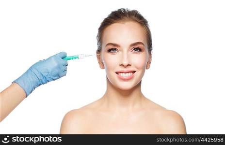 people, cosmetology, plastic surgery and beauty concept - beautiful young woman face and beautician hand in glove with syringe making injection over white background