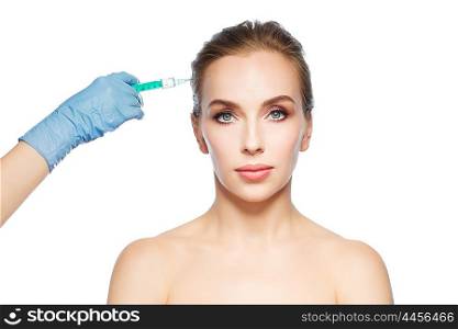 people, cosmetology, plastic surgery and beauty concept - beautiful young woman face and beautician hand in glove with syringe making injection over white background
