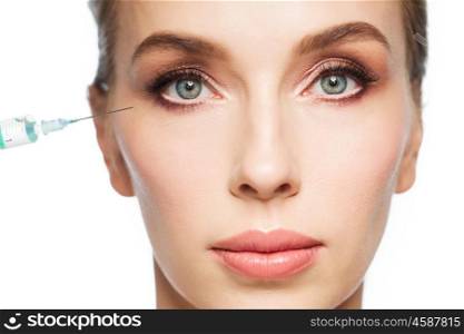 people, cosmetology, plastic surgery, anti-aging and beauty concept - beautiful young woman face and syringe making injection to eye area over white background