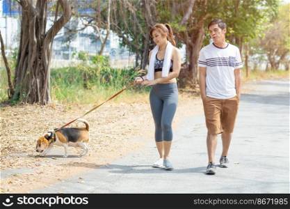 People couple walking with friendly pet beagle dog modern family morning activity for healthy.