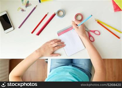 people, creativity and art concept - girl drawing at home. girl drawing in notebook at home