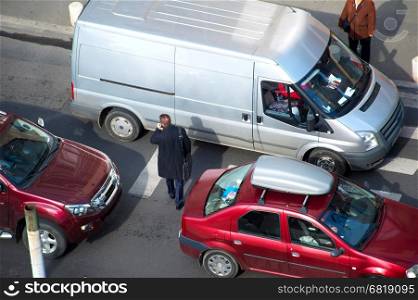 People crossing the road in traffic jam. Aerial view