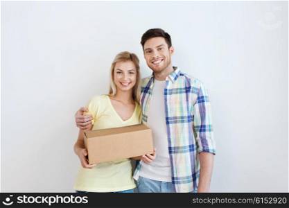 people, delivery, mail, shipping and moving concept - smiling couple with cardboard box