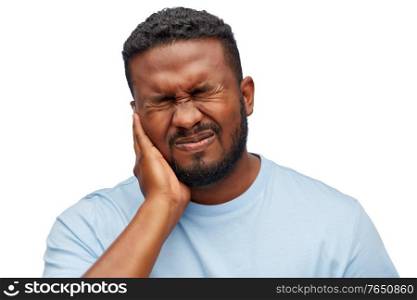 people, dentistry and health problem concept - african american man suffering from toothache over white background. african american man suffering from toothache