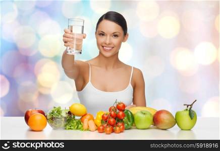 people, diet and vegetarian concept - happy asian woman with healthy food showing glass of water over blue lights background