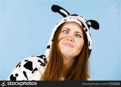 People dressed up like animals concept. Happy crazy woman in funny cow pajamas costume. Happy crazy woman in cow costume