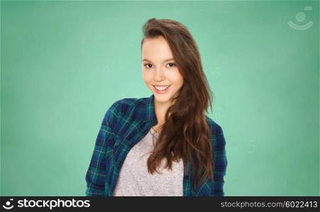 people, education and teens concept - happy smiling pretty teenage student girl over green school chalk board background