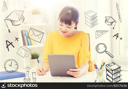 people, education, high school and learning concept - happy asian young woman student in glasses with tablet pc computer, book and notepad writing at home over doodles. asian woman student with tablet pc at home. asian woman student with tablet pc at home