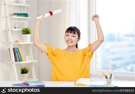 people, education, school, graduation and learning concept - happy asian young woman student with diploma scroll celebrating at home