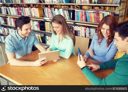people, education, technology and school concept - happy students with tablet pc computer networking in library