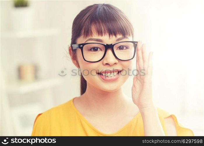 people, education, vision and portrait concept - happy asian young woman or teenage student girl in glasses at home. happy asian young woman in glasses at home. happy asian young woman in glasses at home
