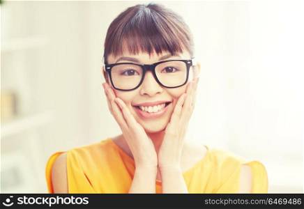 people, education, vision and portrait concept - happy asian young woman or teenage student girl in glasses at home. happy asian young woman in glasses at home