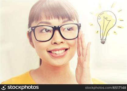 people, education, vision and portrait concept - happy asian young woman or teenage student girl in glasses over light bulb doodle. asian woman in glasses with light bulb doodle. asian woman in glasses with light bulb doodle