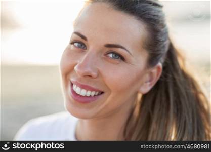people, emotion and facial expression concept - close up of happy smiling young woman face outdoors