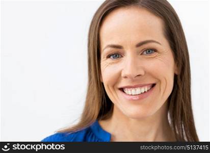 people, emotion and facial expression concept - face of happy smiling middle aged woman. face of happy smiling middle aged woman