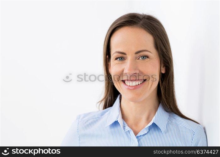 people, emotion and facial expression concept - face of happy smiling middle aged woman or businesswoman. face of happy smiling middle aged woman