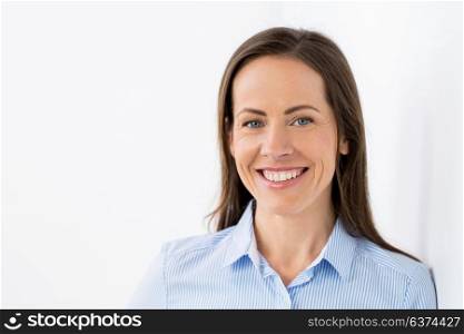 people, emotion and facial expression concept - face of happy smiling middle aged woman or businesswoman. face of happy smiling middle aged woman
