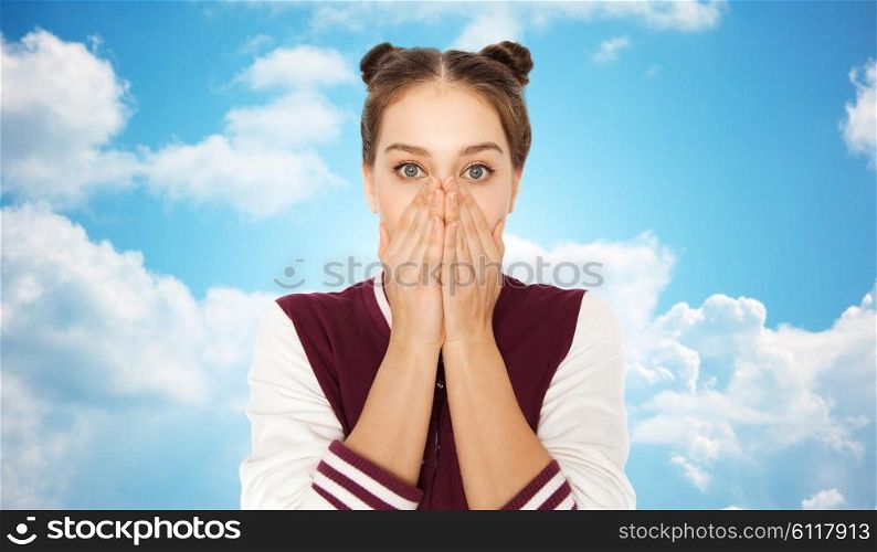 people, emotion, expression and teens concept - scared or confused teenage girl over blue sky and clouds background