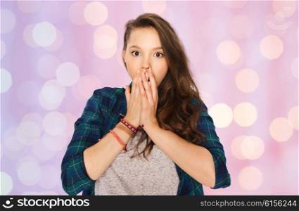 people, emotion, expression and teens concept - scared or surprised teenage girl over pink holidays lights background