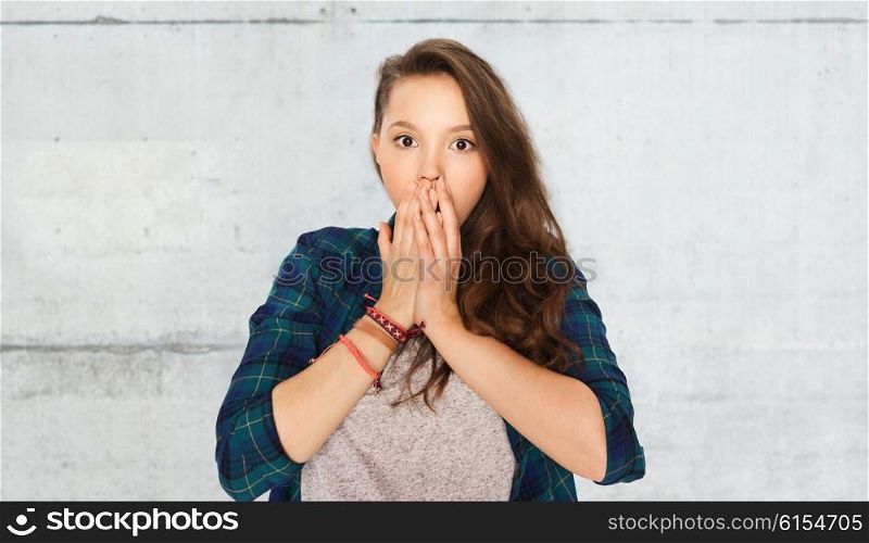 people, emotion, expression and teens concept - scared teenage girl over gray stone wall background
