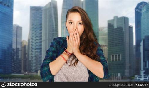 people, emotion, travel and tourism concept - scared teenage girl over singapore city background