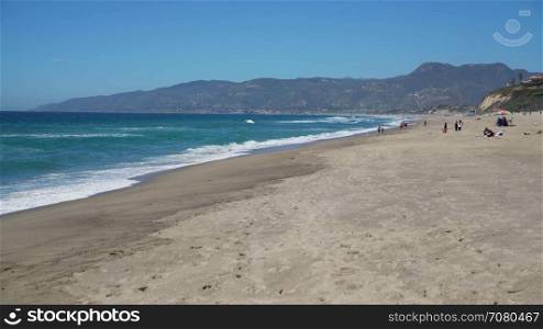 People enjoy the beach at Point Dume