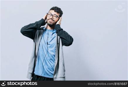People enjoying music with headphones isolated, cheerful guy listening to music with his cell phone isolated, Person listening to music with his cell phone with headphones isolated
