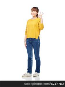 people, ethnicity and gesture concept - happy asian young woman showing ok hand sign over white