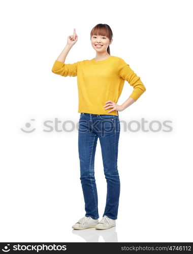 people, ethnicity and idea concept - happy asian young woman pointing finger up over white